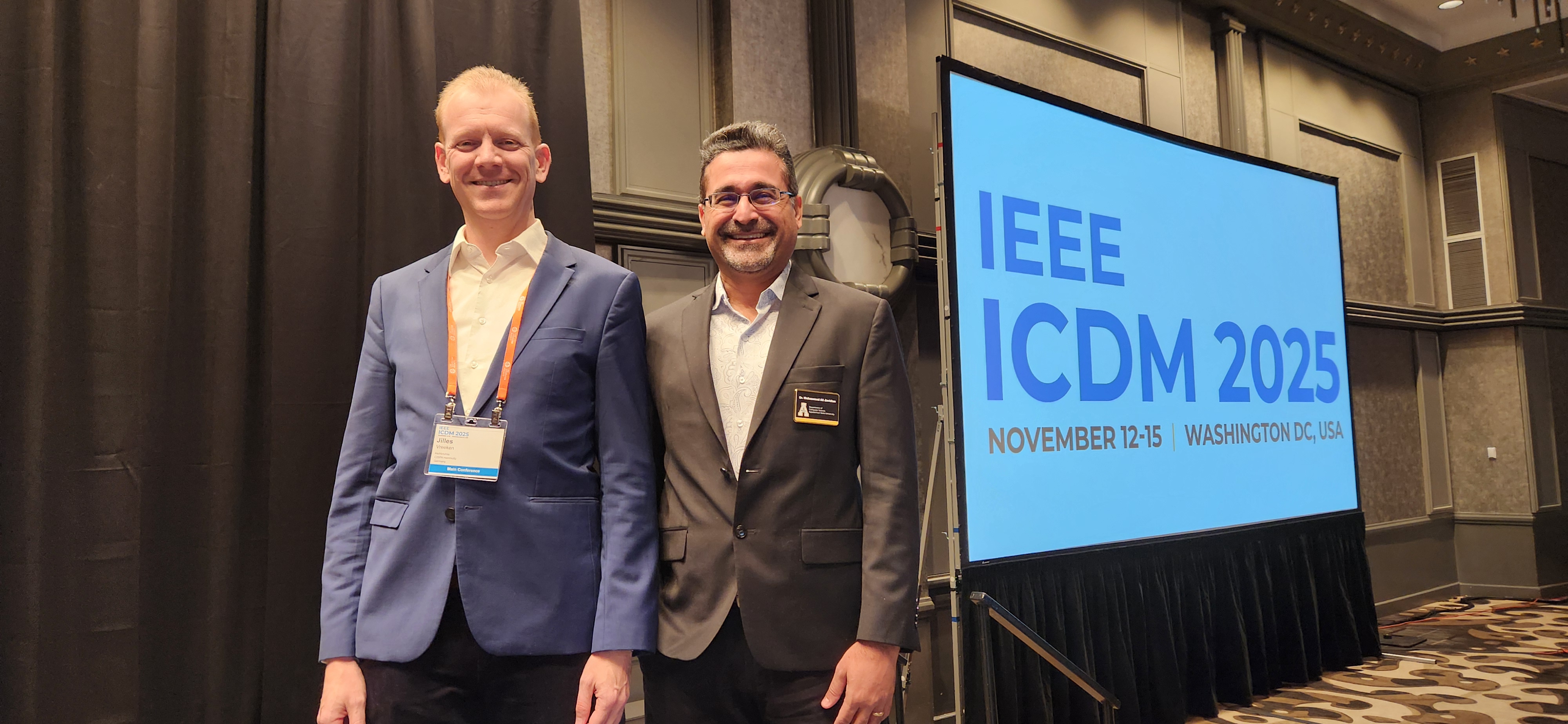 Wide shot of keynote room and ICDM 2025 screen