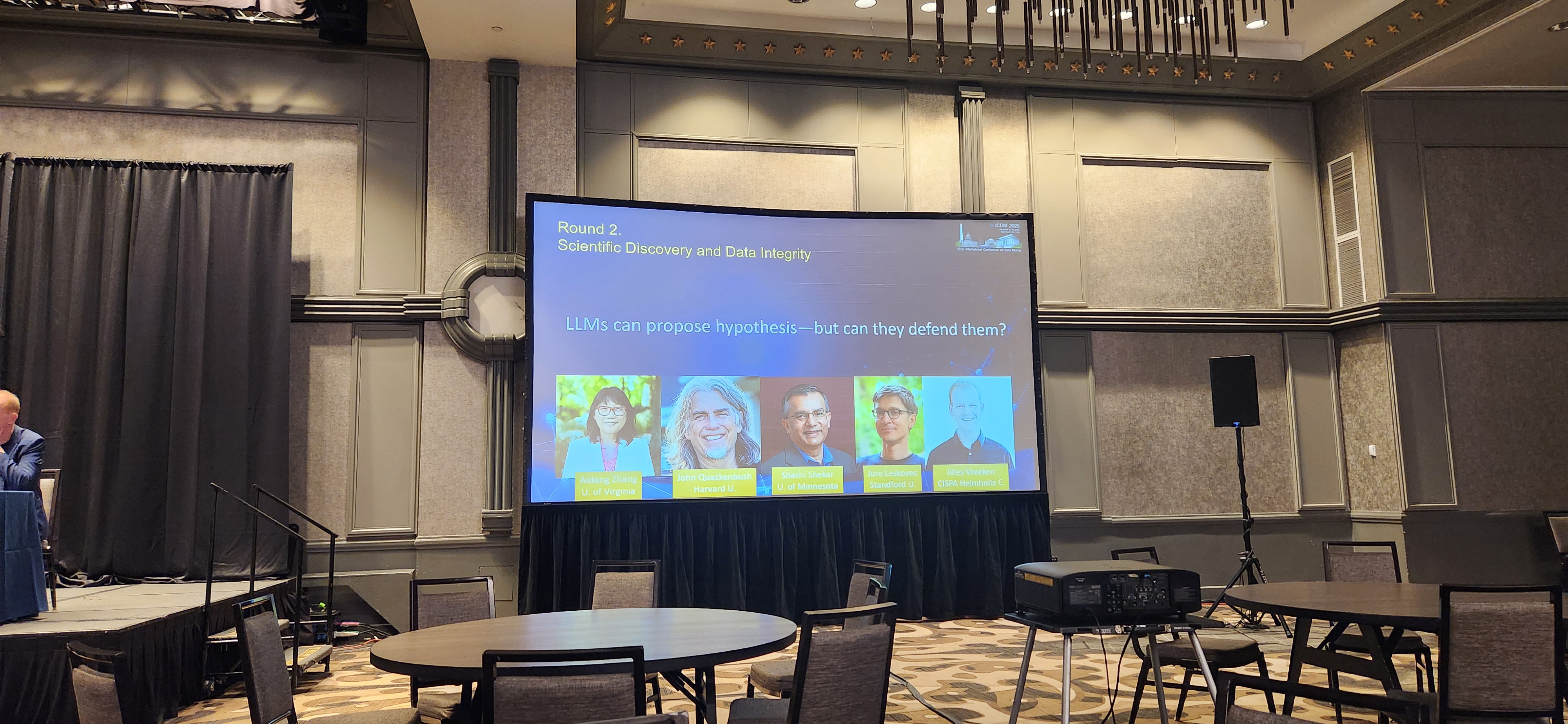 Round 2 panel slide on scientific discovery and data integrity about LLMs proposing hypotheses.