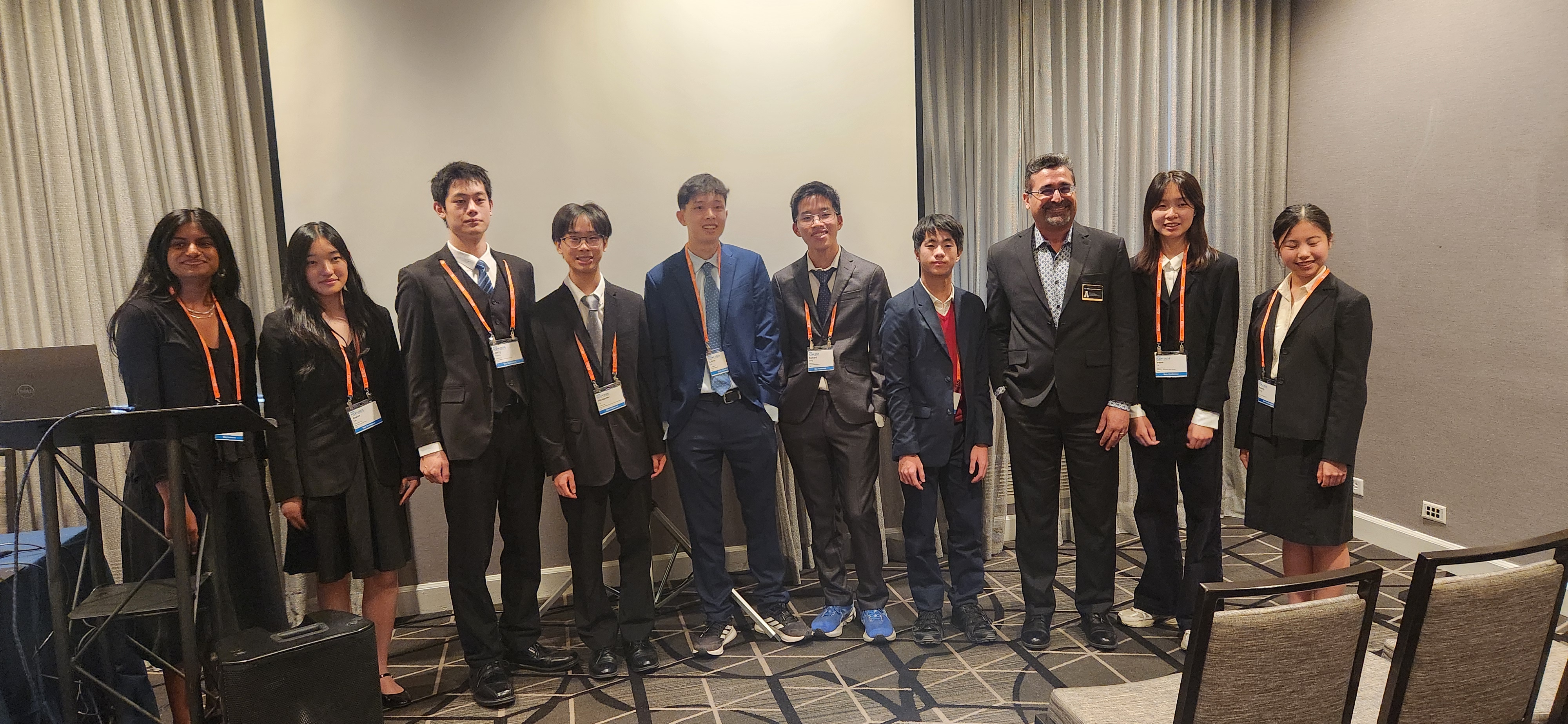 Group photo of session chair with undergraduate and high school presenters.